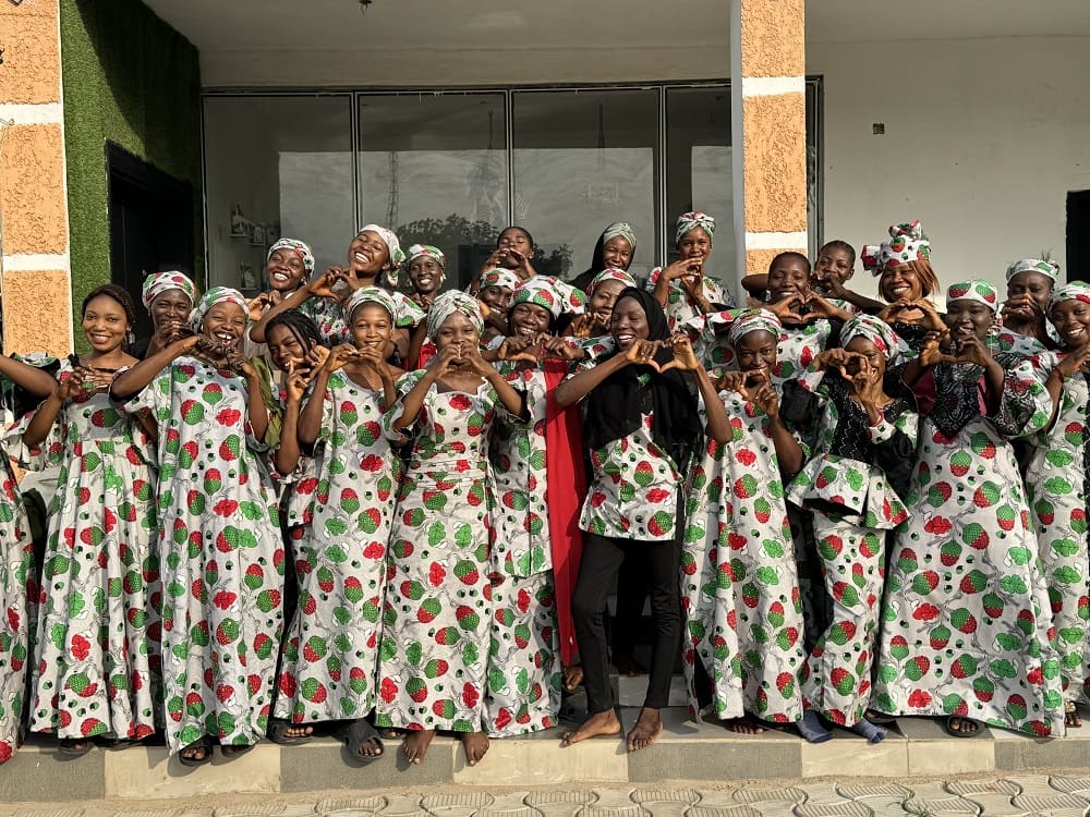 Women making heart shapes with their hands